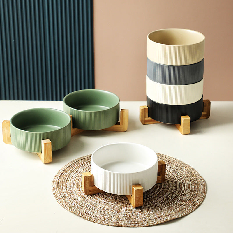 Easy-clean elevated ceramic dog and cat bowls on a chic wooden stand for comfortable dining.