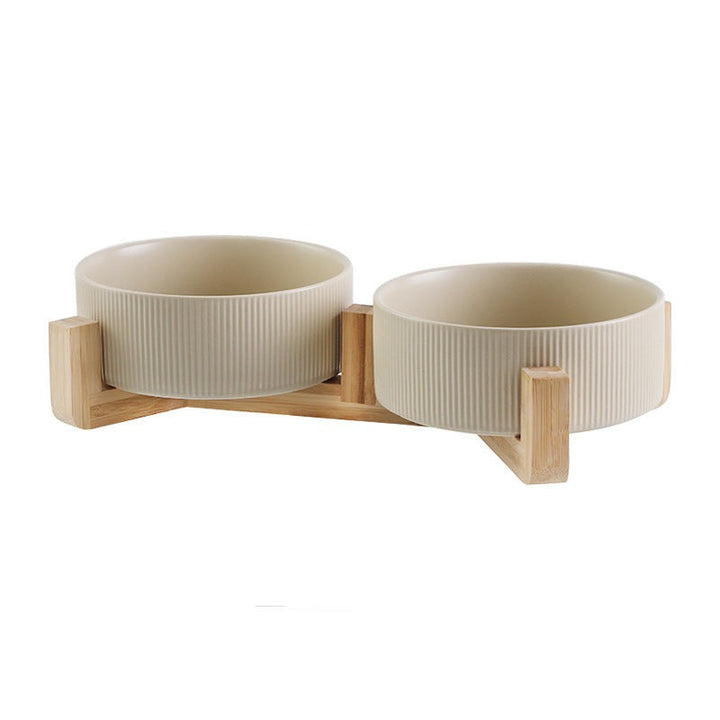 Stylish elevated pet dining set with white ceramic bowls & a sturdy wooden stand.