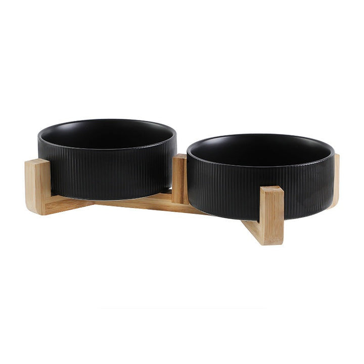 Close-up of easy-clean elevated ceramic pet bowls with a modern wooden stand design.