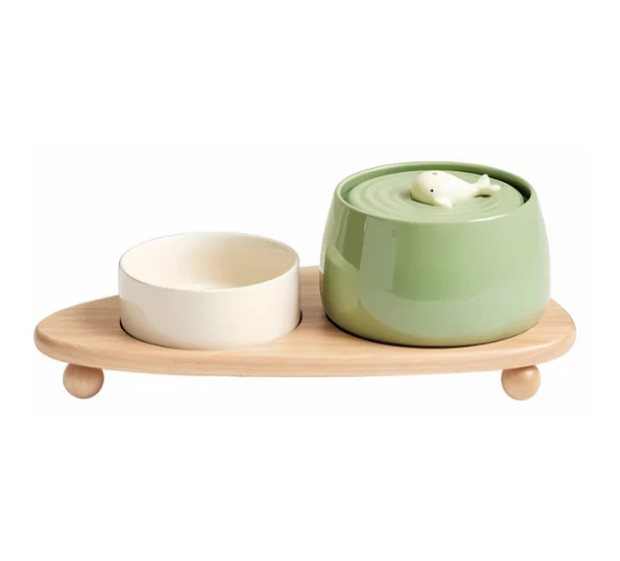Two elevated ceramic dog bowls in a contemporary wooden stand, a stylish and ergonomic pet dining solution.