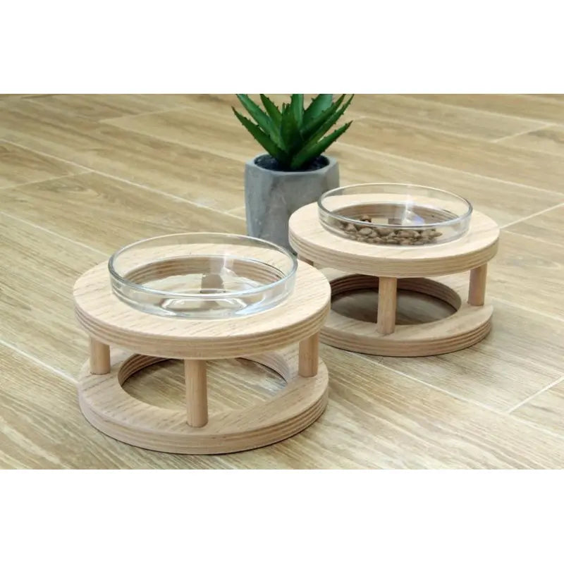 Modern pet feeder featuring a sturdy wooden stand & two removable glass bowls. Easy to clean, durable.