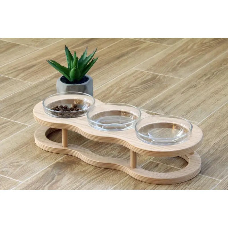 Premium elevated glass pet bowls on an elegant wooden stand. A stylish, healthy dining solution for pets.