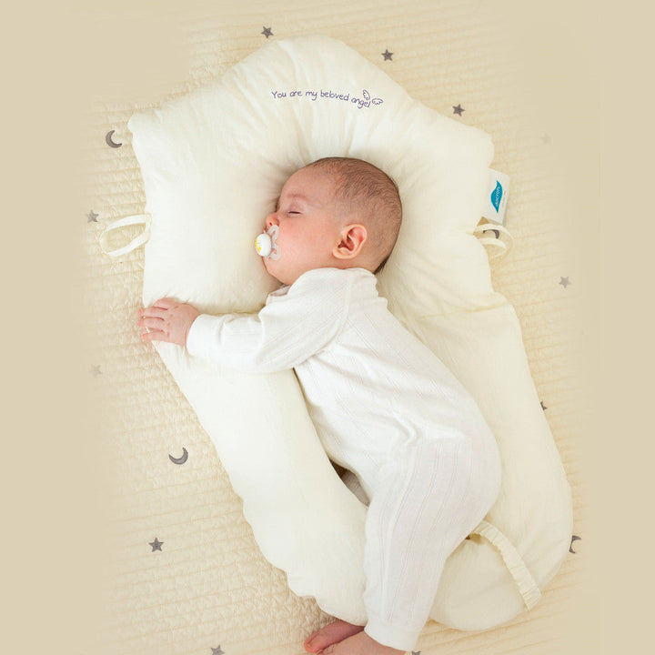 Ergonomic antibacterial baby cuddle cushion providing safe sleep support for infants and newborns.