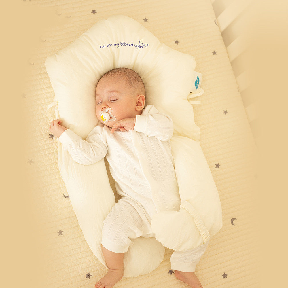 Soft ergonomic baby sleep cushion with antibacterial properties, perfect for newborn comfort and safety.