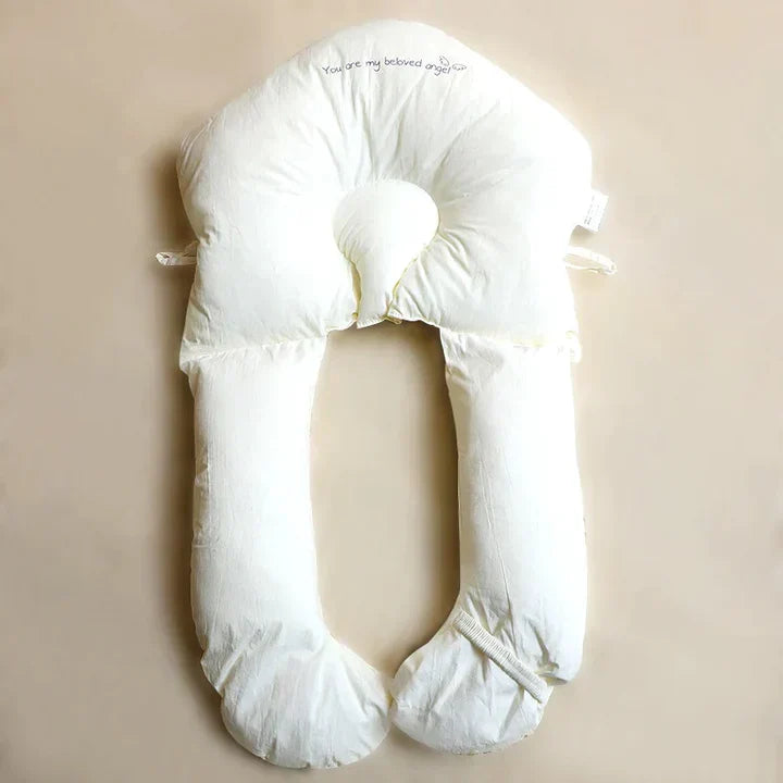 White ergonomic antibacterial baby sleep and cuddle cushion, essential for safe newborn care and support.