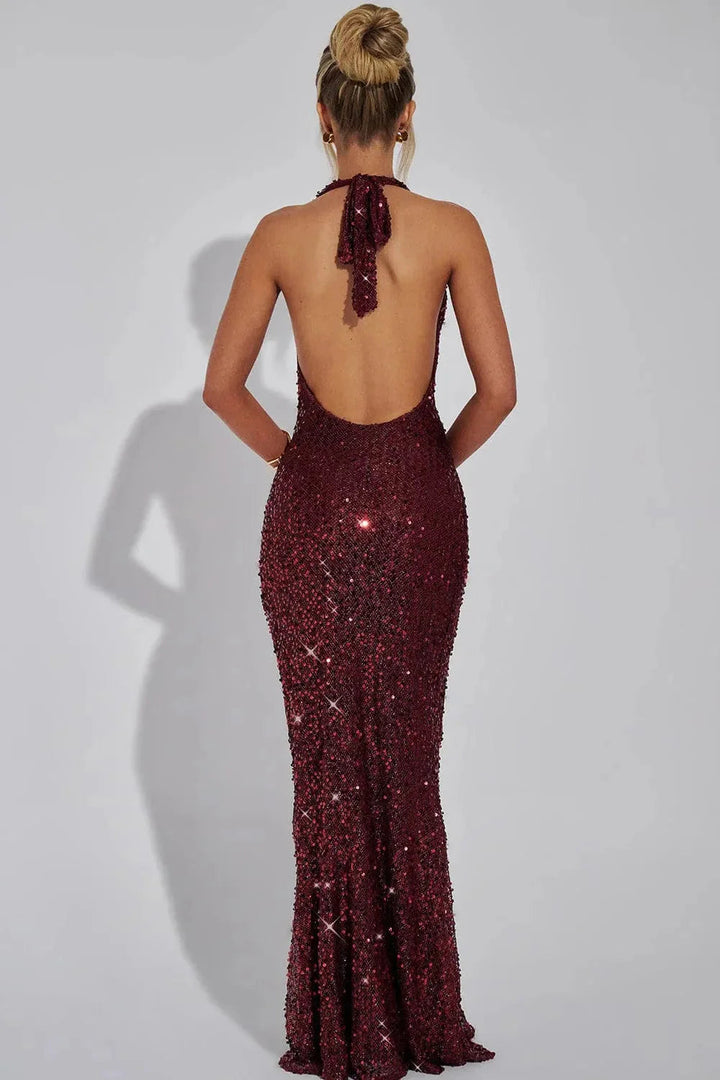 Close-up of women's sequin halter evening maxi dress, showing intricate sequin detail & open back design.