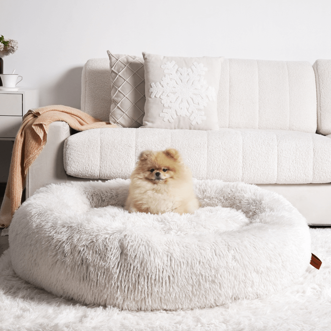 Close-up of luxurious faux fur on a calming donut dog bed, promoting pet comfort & deep sleep.