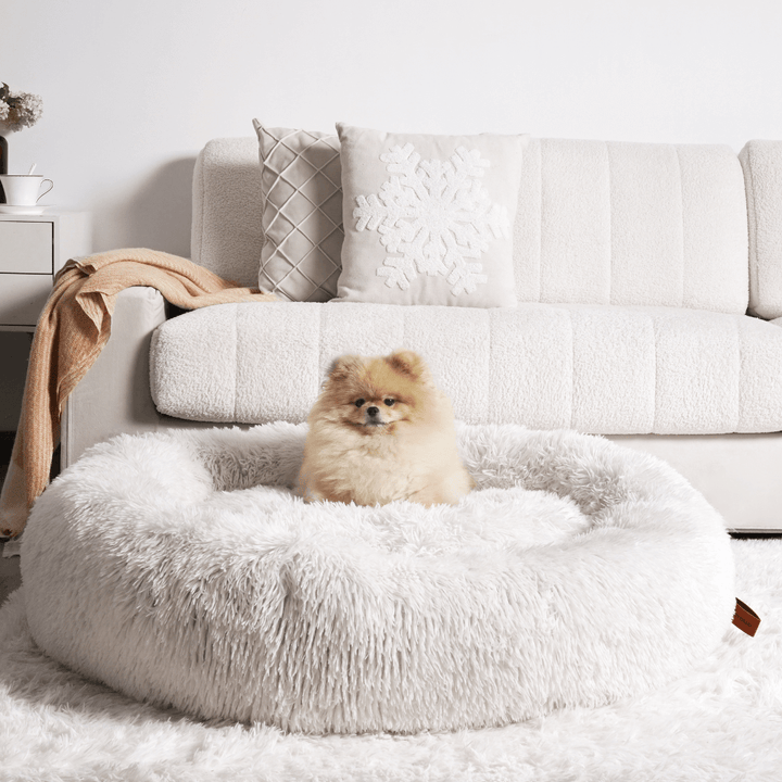 Close-up of luxurious faux fur on a calming donut dog bed, promoting pet comfort & deep sleep.