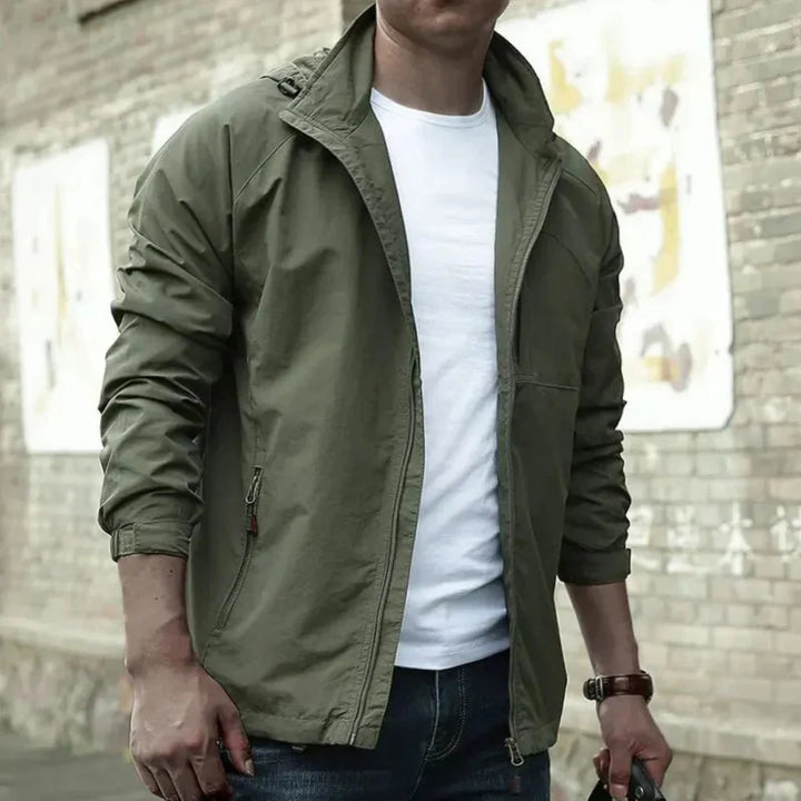 Side profile of a man wearing a blue lightweight transitional jacket, ideal for fall outerwear