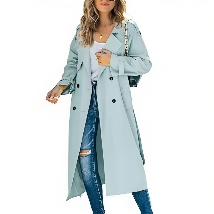 Close-up of a woman in a classic long trench coat, showing belted detail, lapels, and buttons. Women's apparel.