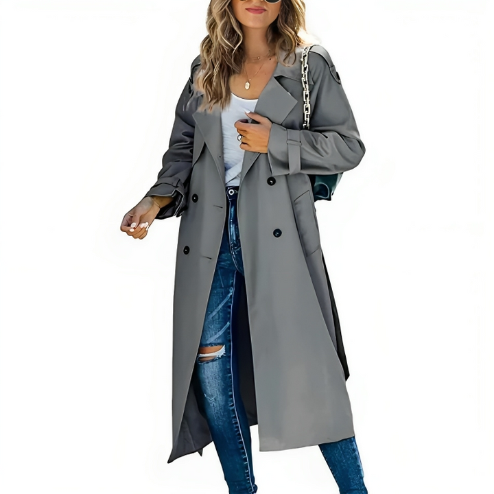 Back view of a woman wearing a long classic belted trench coat, suitable for spring or autumn. Women's fashionable outerwear.