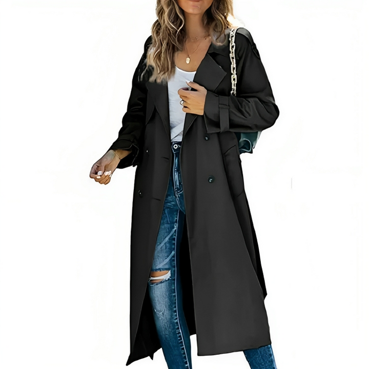 Studio shot of a woman modeling a sophisticated long trench coat with a belt, a classic and new autumn jacket.