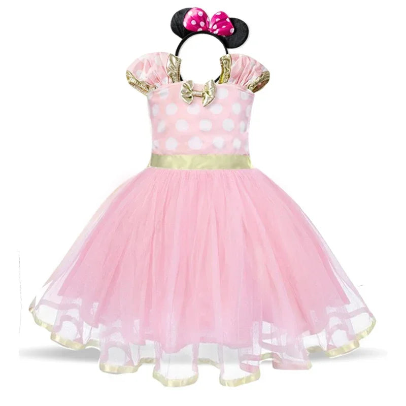 Young girl happily posing in her Minnie Mouse polkadot dress costume with a cute bow ear headband.