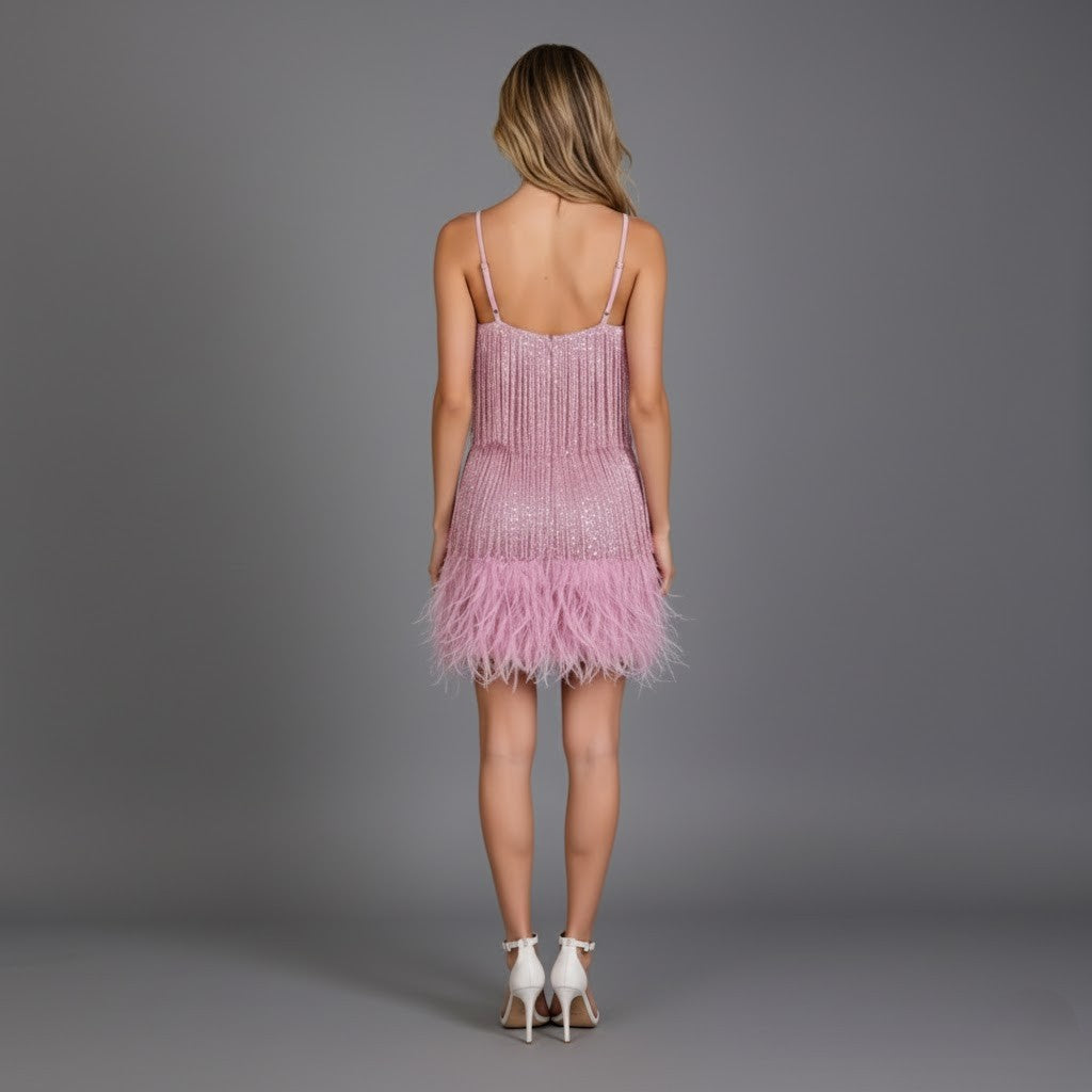 Stylishly posed woman in a red fringe feather mini cocktail dress, ready for an evening event.