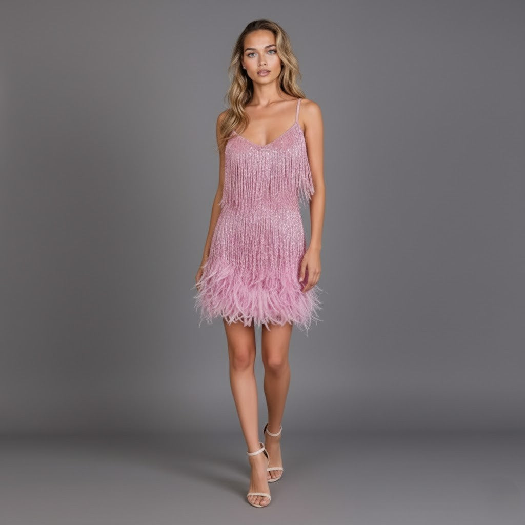 Women's fringe feather mini dress paired with high heels and clutch, complete night out look.