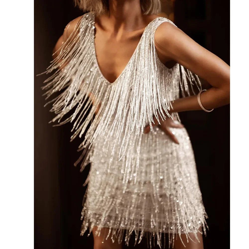 Stunning women's cocktail dress featuring shimmering sequins and elegant fringe accents, evening wear