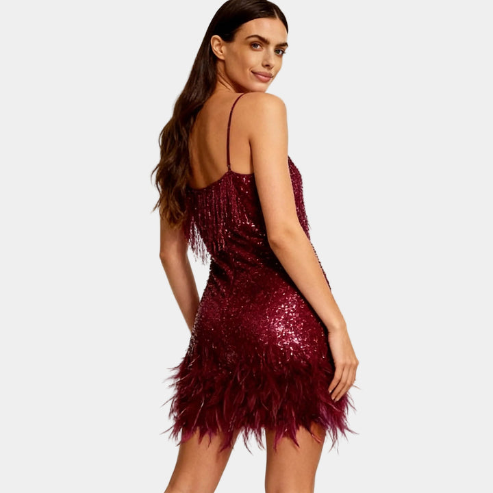 Full shot of a women's sequin feather mini dress, designed for a show-stopping party look.