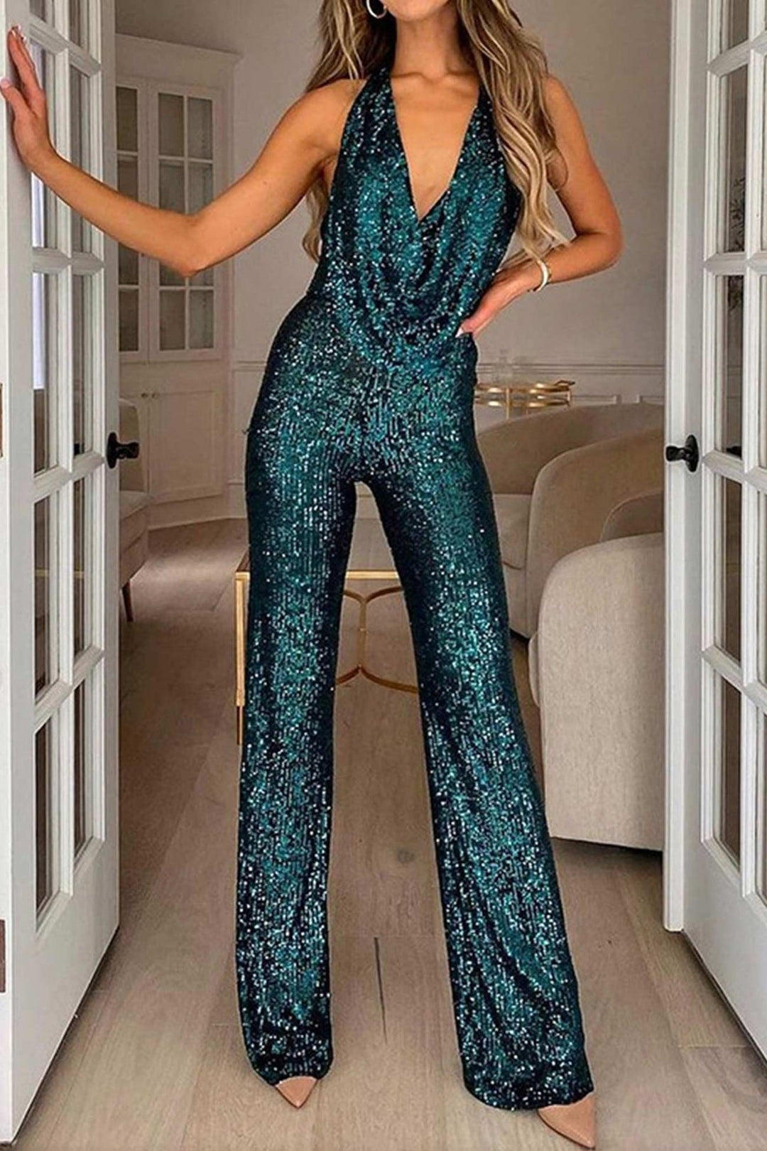 Stylish women's party outfit: a sequin halter jumpsuit with wide legs and an elegant, comfortable fit.