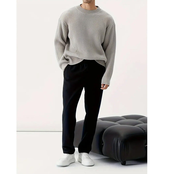 Men's long sleeve grey crewneck sweater with a relaxed fit. Ideal for comfortable, casual everyday fashion wear.