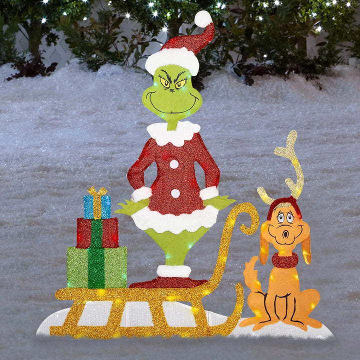 Grinch holiday garden decor, brightly lit with LEDs, a cheerful outdoor Christmas yard ornament.