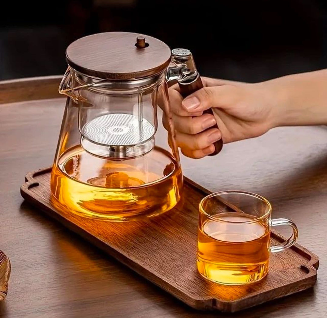 Elegant glass teapot with a tea infuser, made from heat-resistant borosilicate glass, ideal for brewing and serving tea.