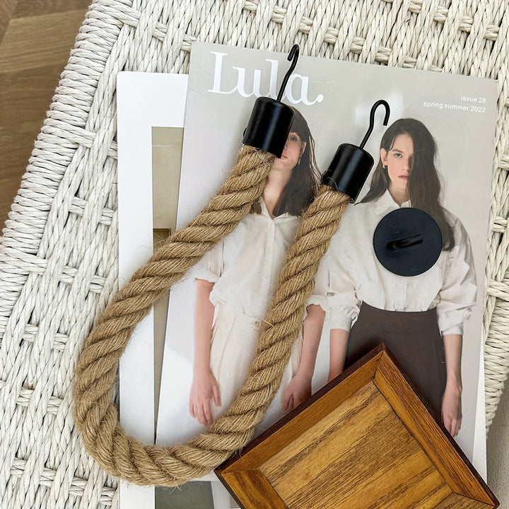 Rustic bathroom toilet paper holder, made with natural hemp rope. Wall-mounted for easy style.