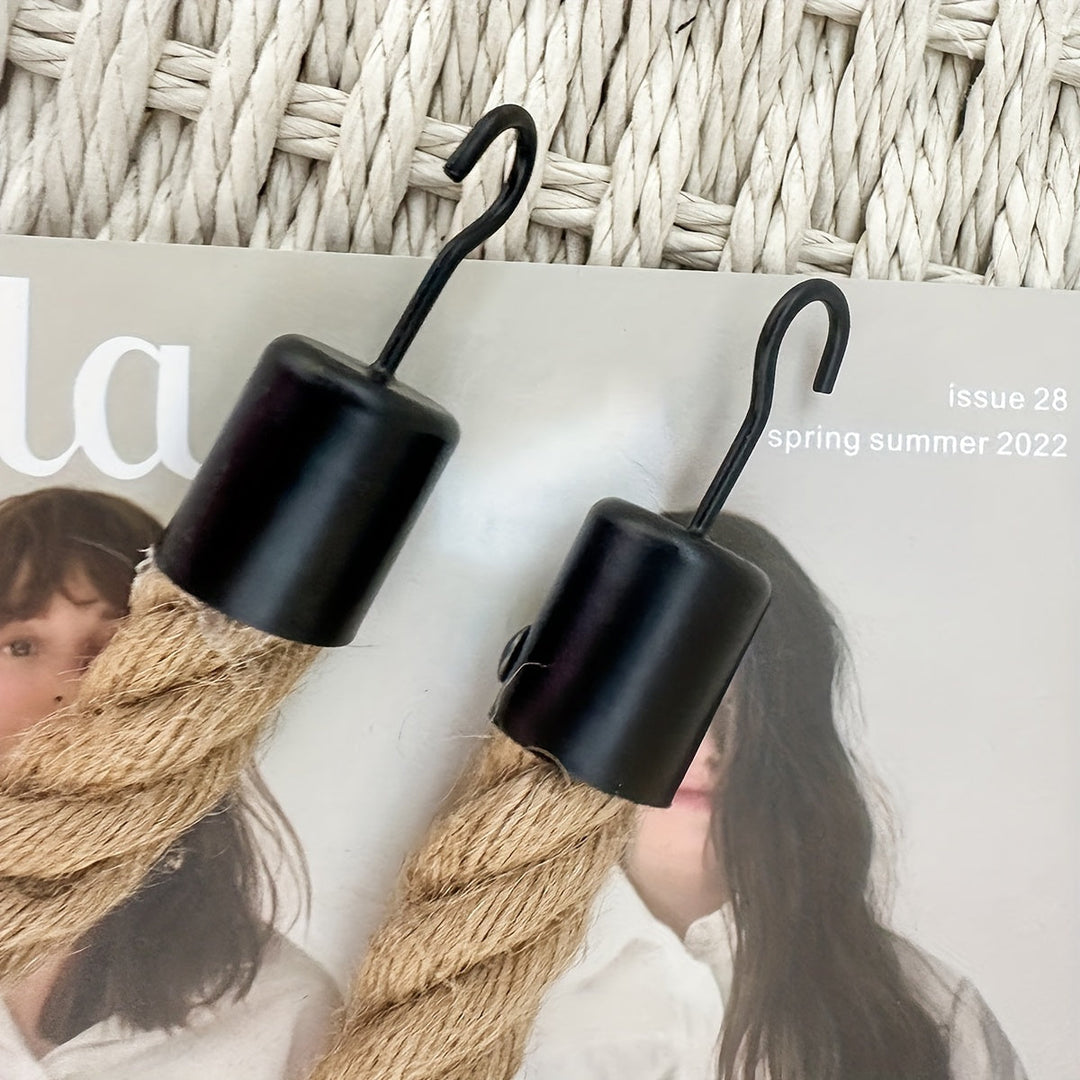 Hemp rope wall-mounted toilet paper holder. Ideal rustic bathroom storage, natural home decor element.