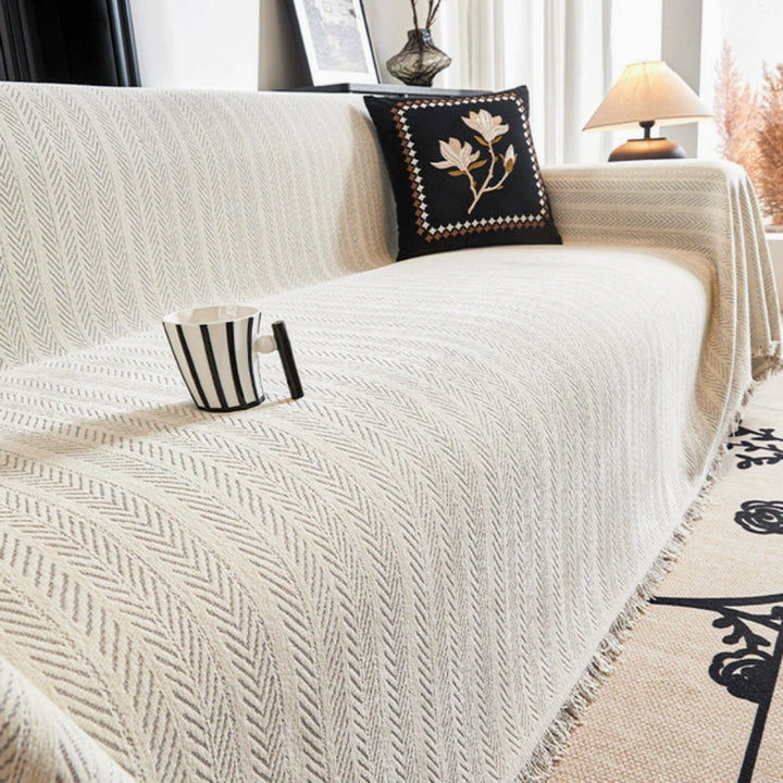 New 3-seater herringbone chenille sofa cover with tassels, ideal for interior design and furniture protection.