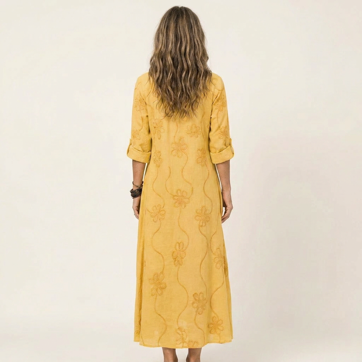 Delicate floral embroidered maxi dress for women. Elegant summer fashion with A-line design.
