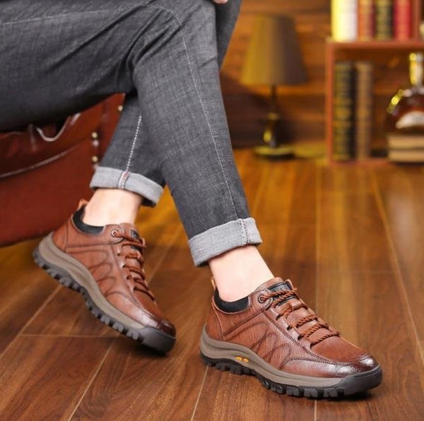 Detailed view of men's rugged textured low top lace-up shoes. Round toe design for everyday casual wear.