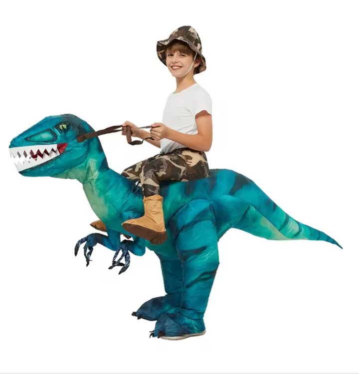 Children having active fun with a large inflatable blue dinosaur ride-on toy outdoors; perfect for summer play.