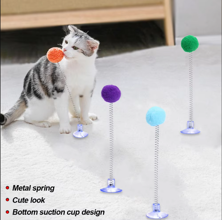 Suction cup interactive cat toy; a shuttlecock with a pompom for stimulating feline play & exercise.