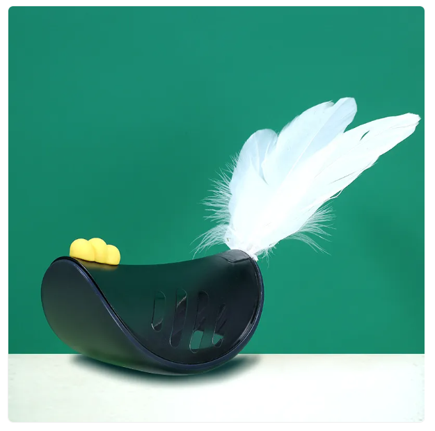 Close-up of the feather and treat dispenser mechanism on an interactive cat toy.