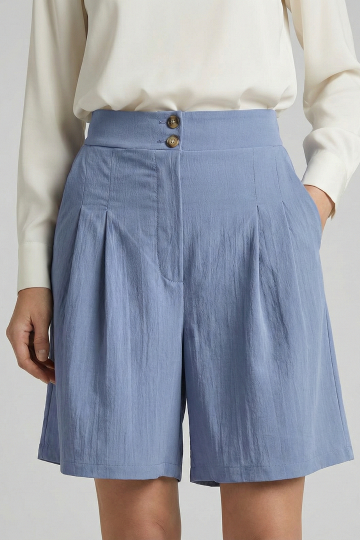 Black high waist pleated tailored shorts paired with a complementary top.