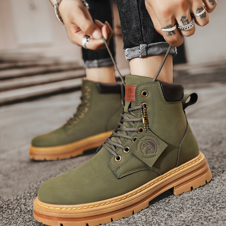 Close-up of men's durable laced hiking boots in khaki, showcasing material and construction.