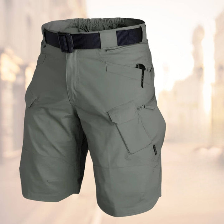 Black men's utility shorts, featuring secure pockets & durable fabric, designed for rugged outdoor use.