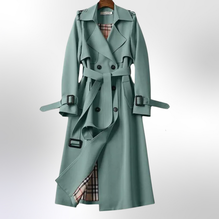 Side profile of a woman wearing an elegant navy trench coat, depicting its silhouette