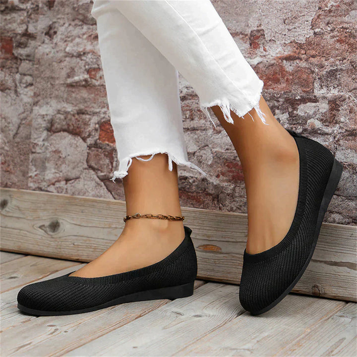 Pair of women's comfortable ballet flats in versatile black, suitable for spring fashion.