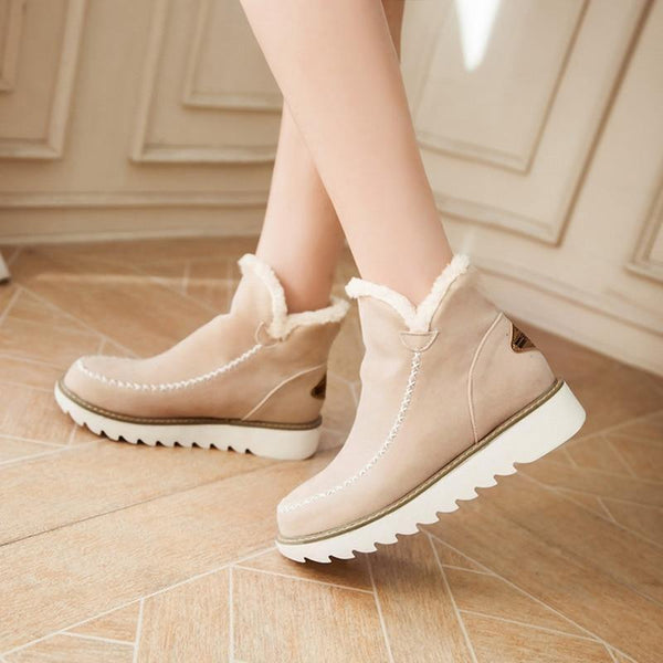 Side view of brown insulated women's boots, displaying waterproof and ankle high design
