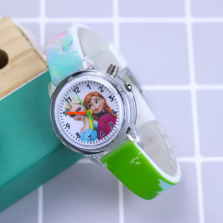 Close-up: Kids' glow-in-the-dark watch dial with cartoon characters and clear numbers.