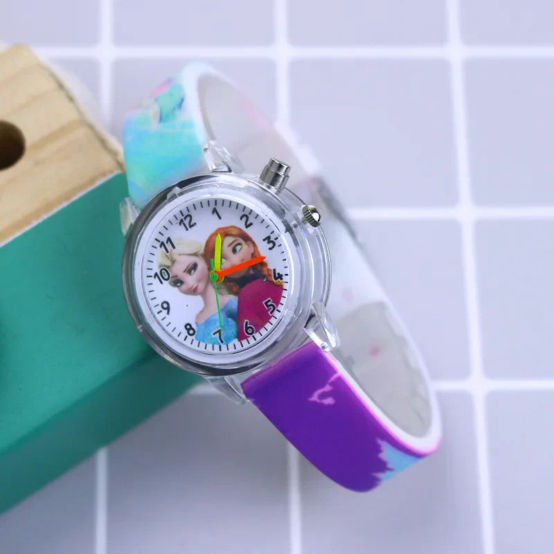 Child wearing a glow-in-the-dark Frozen watch, blue silicone strap for girls.