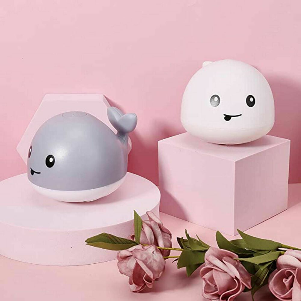 Cute whale-shaped bath toy that sprinkles water and lights up, making a splash in the tub for babies and kids.