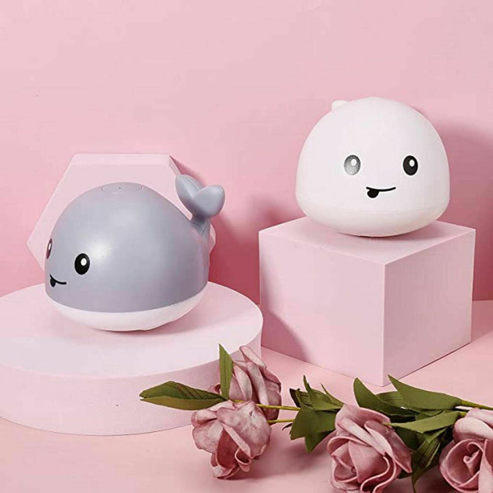 Cute whale-shaped bath toy that sprinkles water and lights up, making a splash in the tub for babies and kids.