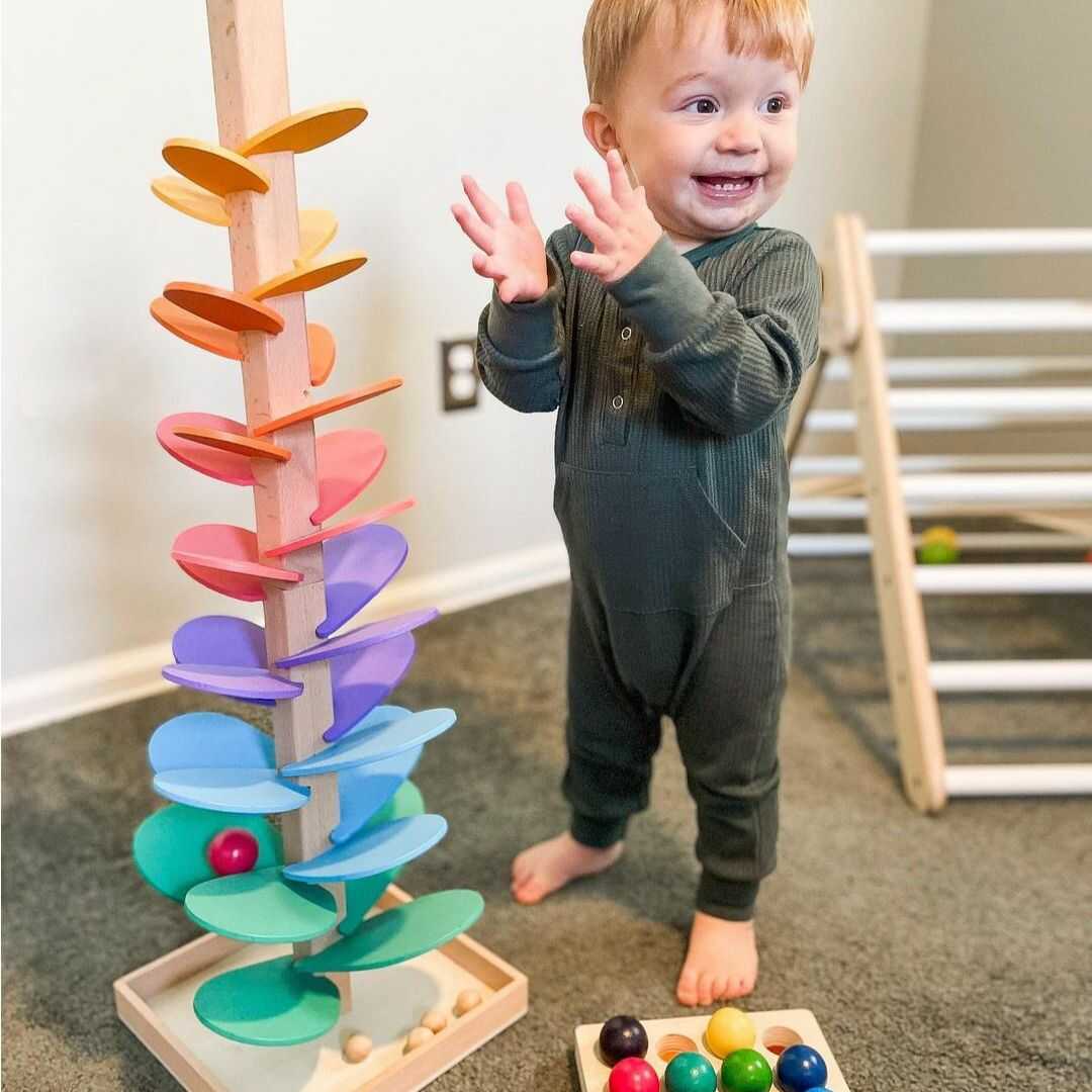 Kids' wooden rainbow sound tower with colorful rings, an educational sensory toy for toddlers & preschoolers.