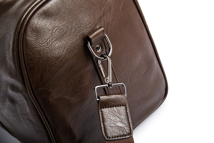 Unisex brown PU leather travel luggage, durable large duffel for journeys.