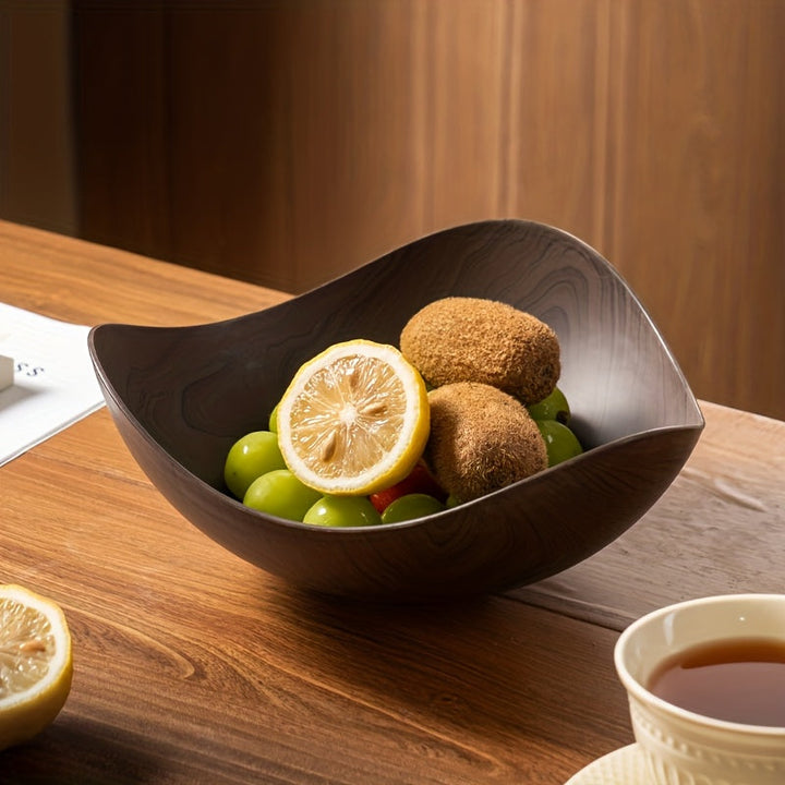 Large decorative wood look fruit bowl. Adds an organic, modern touch to any kitchen table.