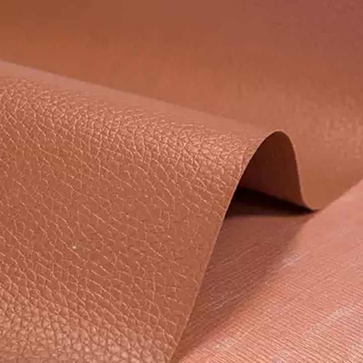 Durable self-adhesive patch for repairing tears in leather and vinyl furniture, car seats.