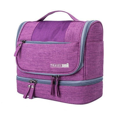 View of open multi-compartment hanging toiletry bag, organizing makeup brushes & travel accessories.