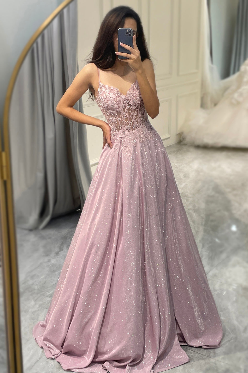 Close-up of the intricate embellishments on a light pink maxi dress, suitable for special occasions.