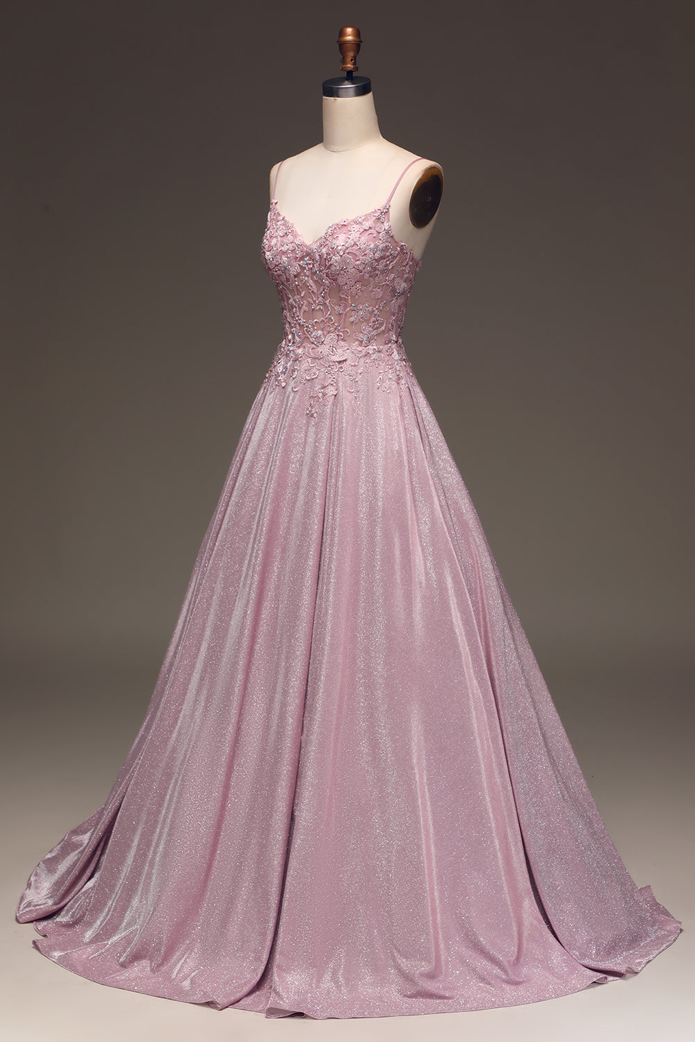 Detail of the bodice and embellishments of a women's light pink maxi dress, perfect occasion wear.